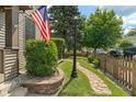 Landscaped front yard featuring a curved walkway, vibrant green bushes, and manicured lawn at 718 E Washington St, Lebanon, IN 46052