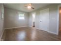 Cozy bedroom with a ceiling fan, wood-look floors, and abundant natural light at 7300 N Banta Rd, Bargersville, IN 46106