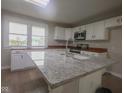 Bright kitchen features granite counters, stainless appliances and a large island at 7300 N Banta Rd, Bargersville, IN 46106