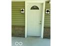A well-lit front entry features a front door with decorative glass at 7529 N Green Meadows, Fairland, IN 46126