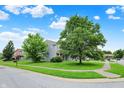Charming two-story home featuring blue siding, brick accents, and well-manicured lawn and sidewalk access at 8212 Twin River Dr, Indianapolis, IN 46239