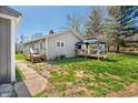 Side view of the home with neutral siding, inviting covered deck, and a well maintained backyard at 9267 N State Road 135, Morgantown, IN 46160