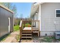 Outdoor deck and steps leading to home's side entrance, near a detached garage at 9267 N State Road 135, Morgantown, IN 46160