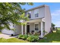 Charming two-story home with gray siding, a two-car garage, and a well-maintained front lawn at 9497 W Stargazer Dr, Pendleton, IN 46064