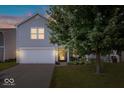 Charming two-story home with gray siding, a two-car garage, and a well-maintained front lawn at 9497 W Stargazer Dr, Pendleton, IN 46064