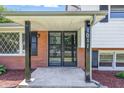 Inviting front porch with brick accents and black metal details, leading to the home's entrance at 1011 Robin Dr, Anderson, IN 46013