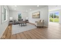 Bright living room featuring hardwood floors, recessed lighting, and large windows with natural light at 1011 Robin Dr, Anderson, IN 46013