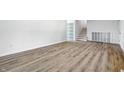 Spacious living room with modern laminate flooring and staircase, freshly painted at 1011 Robin Dr, Anderson, IN 46013