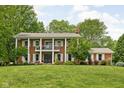 Charming two-story brick house with a grand columned porch and manicured lawn at 10198 N State Road 75, North Salem, IN 46165