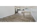 Open-concept living room with luxury vinyl flooring and abundant natural light at 10434 N Delaware St, Carmel, IN 46280