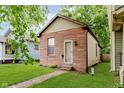 Charming home featuring a red brick facade, green lawn, and a classic design at 1051 Elm St, Indianapolis, IN 46203