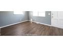 Empty living room showcasing wood floors and natural light from the windows at 1217 S Ewing St, Indianapolis, IN 46203
