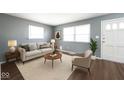 Inviting living room featuring wood floors, stylish decor, and abundant natural light at 1217 S Ewing St, Indianapolis, IN 46203