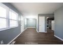 This light-filled living room features hard wood flooring and modern neutral paint at 1217 S Ewing St, Indianapolis, IN 46203