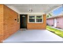 Spacious front porch with a covered entrance and a view of the home's charming brick facade at 1231 N Graham Ave, Indianapolis, IN 46219