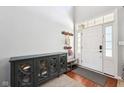 Bright foyer featuring a high ceiling, wood floors, and stylish cabinet at 12404 Guy Way, Indianapolis, IN 46236