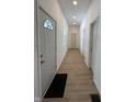 Bright hallway featuring wood-look flooring, fresh white walls, and recessed lighting at 1256 Kappes St, Indianapolis, IN 46221