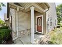 Welcoming front porch with classic white column and decorative front door at 1311 Flintlock Dr, Greenwood, IN 46143