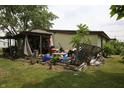 Enclosed back porch filled with various items and leading to the home's entrance at 1325 N Gavin St, Muncie, IN 47303