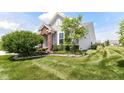 Landscaped front yard showing a brick entryway, mature tree and manicured green lawn at 13427 Merryvale St, Fishers, IN 46037
