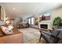 Open-concept living room featuring recessed lighting, hardwood floors, a cozy fireplace, and comfortable seating at 14404 Stairbridge Pl, Carmel, IN 46074