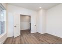 A bright, empty bedroom with hardwood floors and large windows is ready for customization at 14514 Hanford Ln, Carmel, IN 46074