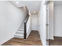Bright foyer with wood flooring, staircase with carpet runner, and access to other rooms at 14514 Hanford Ln, Carmel, IN 46074
