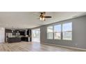 Open concept living space with kitchen view showcasing dark cabinets, stainless steel appliances, and breakfast bar at 14620 Hinton Dr, Fishers, IN 46037