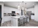 Beautiful kitchen with white cabinetry, stainless steel appliances, granite countertops, and bar stool seating at 18980 Seaforth Way, Westfield, IN 46074