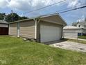 View of a detached one-car garage with light-colored siding and a white garage door at 1902 Westview Dr, Indianapolis, IN 46221