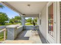 Cozy front porch with a table and chairs, offering a relaxing outdoor seating area at 1927 N Cherry St, Columbus, IN 47201