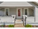 Inviting front porch featuring a red door, brick accents, and a welcoming entryway at 1927 N Cherry St, Columbus, IN 47201