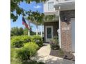Charming front entrance with brick facade, American flag, and well-manicured landscaping at 2485 Blue Ridge Dr, Greenwood, IN 46143