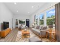 Bright living room with hardwood floors, modern furniture, and large windows offering a pleasant view at 2709 Station St, Indianapolis, IN 46218