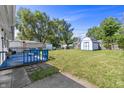 Spacious backyard featuring a blue deck, storage shed, and ample green space at 2829 Dakota Dr, Anderson, IN 46012