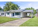 Inviting single-story home with a covered carport and well-kept front yard and driveway at 2829 Dakota Dr, Anderson, IN 46012