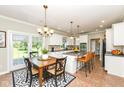 Bright kitchen with white cabinetry, island seating, and adjacent dining area at 3050 Montgomery Blvd, Lapel, IN 46051