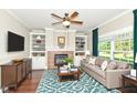 Cozy living room with a fireplace, built-in shelving, and large windows at 3050 Montgomery Blvd, Lapel, IN 46051