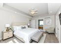 Spacious primary bedroom with a tray ceiling, fan, and ensuite bathroom entrance at 3050 Montgomery Blvd, Lapel, IN 46051