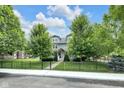 Attractive home with iron fence, green trees and lawn with sidewalk view at 3101 N Washington Blvd, Indianapolis, IN 46205