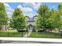 Beautiful gray home with black fence and lush green lawn and landscaping at 3101 N Washington Blvd, Indianapolis, IN 46205