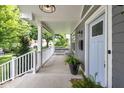 Relaxing front porch with outdoor seating and stylish blue front door at 3101 N Washington Blvd, Indianapolis, IN 46205