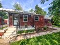 Charming bungalow featuring a covered porch, brickwork, and well-kept front yard at 319 S Webster Ave, Indianapolis, IN 46219