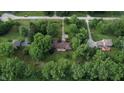 Secluded ranch home surrounded by lush trees and greenery, featuring a long driveway and large lawn at 3711 Tara Ct, Carmel, IN 46074
