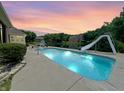 Backyard pool area, with a slide and relaxing seating near the lake providing the perfect spot for summer fun at 3893 Bent Tree Ln, Greenwood, IN 46143