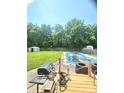 Large, grassy backyard features a covered pool and grill, perfect for outdoor entertaining at 430 N Greenbriar Dr, Greenwood, IN 46142