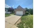 Well maintained two-story brick home with an attached two-car garage and manicured lawn at 430 N Greenbriar Dr, Greenwood, IN 46142