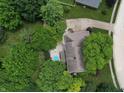 Aerial view of a house with a large backyard, including a swimming pool surrounded by mature trees at 4976 Rockne Cir, Carmel, IN 46033