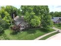A charming two-story home with mature trees and manicured lawn on a quiet street at 4976 Rockne Cir, Carmel, IN 46033