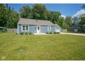 Charming blue home with a well-maintained lawn and a detached one-car garage at 5902 Oak Ln, Anderson, IN 46013